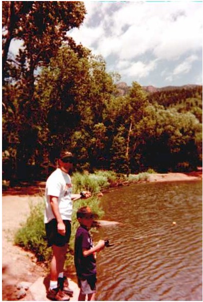 Shane teaching Nathan how to fish.